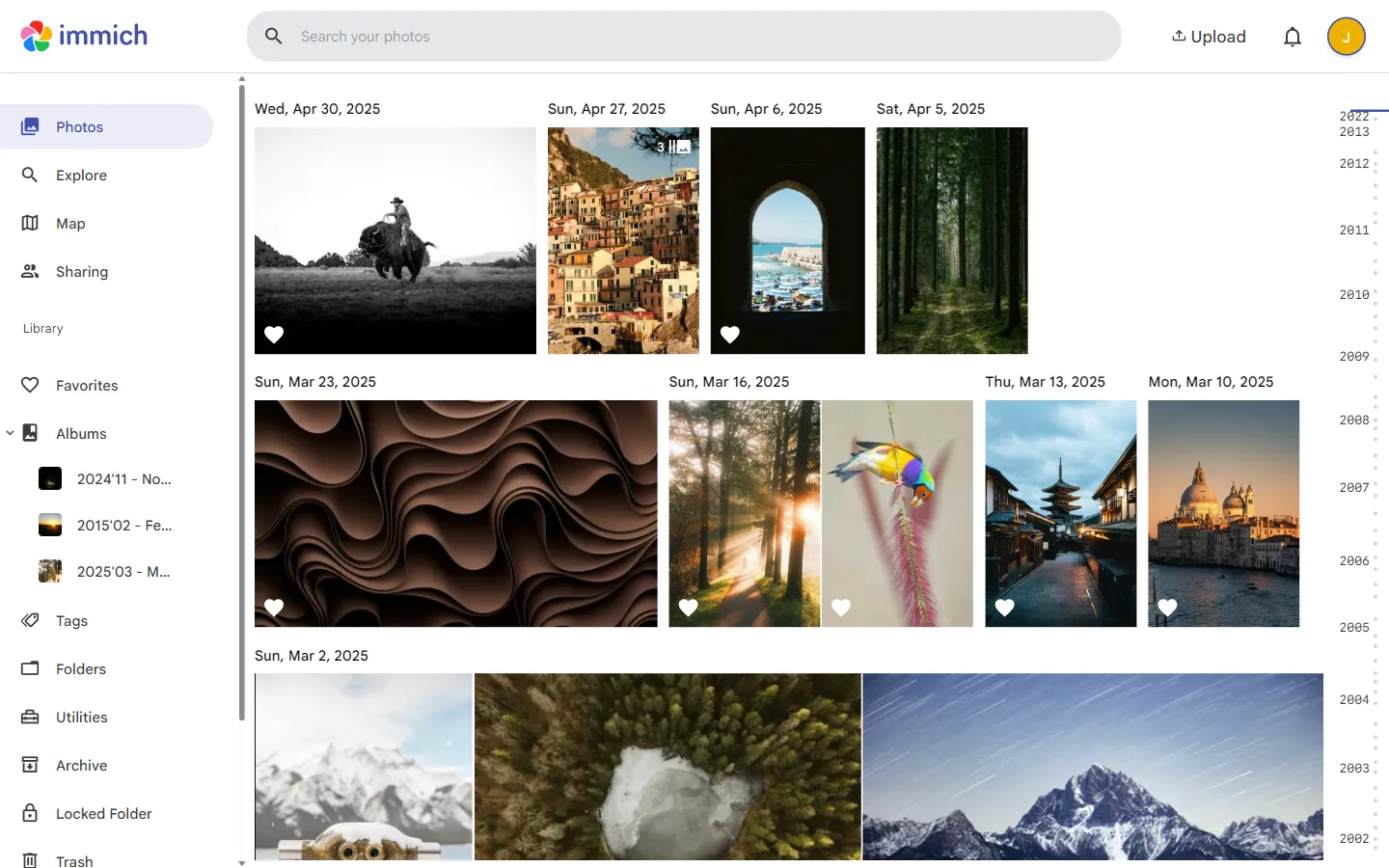 The Immich web app showing a photo timeline grouped by date, with albums in the sidebar
